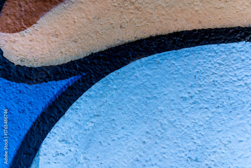 Art under ground. Beautiful street art graffiti background. The brick wall is decorated with abstract drawings house paint. Modern style urban culture of street youth. Abstract picture on wall