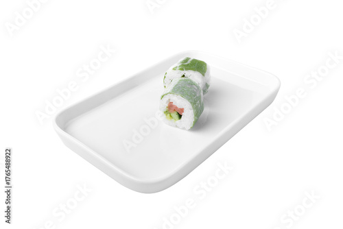 side view of cabbage wrapped salmon sushi roll with avocado and cucumber