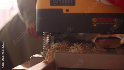 A woodworking machine is being used to cut wood