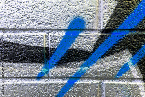 vivid street graffiti texture of colotful spray painting strips on gray metallic brick background, urban culture of modern youth backdrop