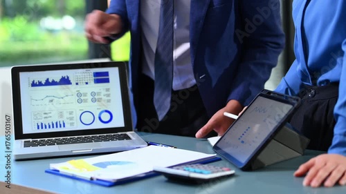 Businessman and team analyzing financial statement Finance task. with smart phone and laptop and  tablet. Wealth management concept