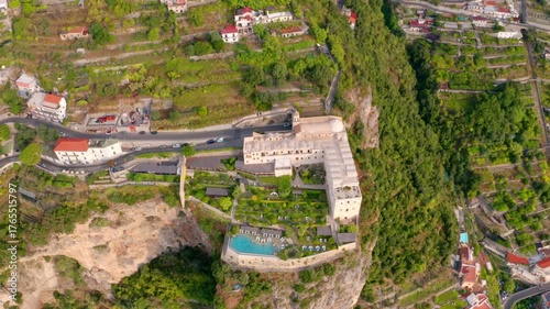 4K aerial - a bird's eye view video (Ultra High Definition) of Santa Maria di Grado palace, located on the huge cliff on Mediterranean coast of Italy. Picturesque summer scene of italian countryside.