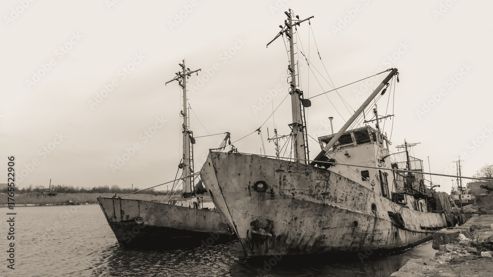 Fototapeta premium sunken and broken ships in a destroyed port in Ukraine during the war