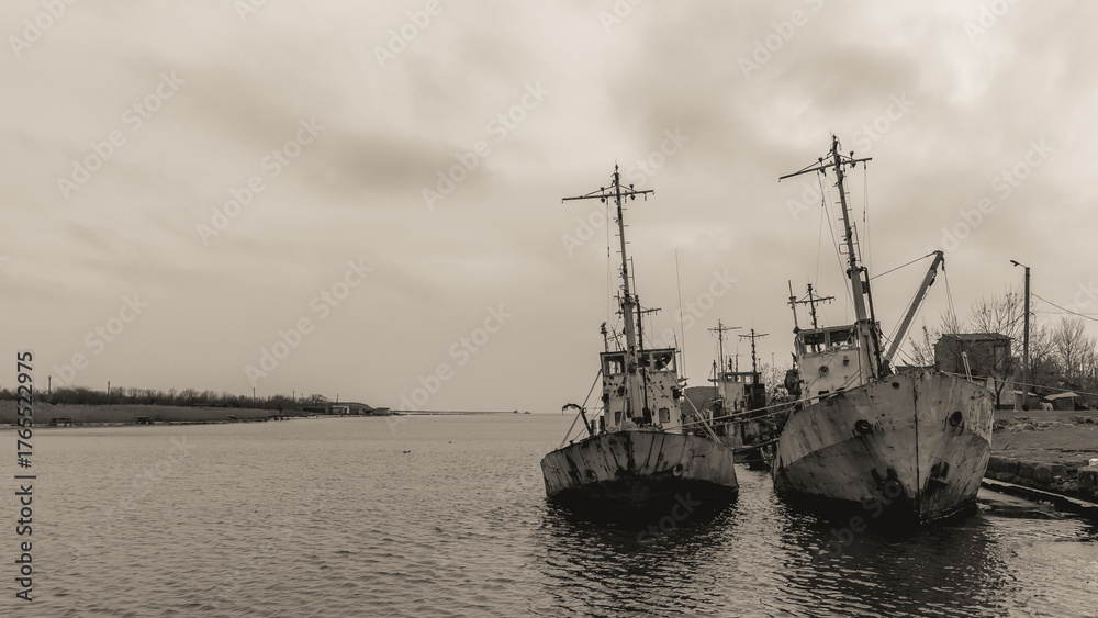 Fototapeta premium sunken and broken ships in a destroyed port in Ukraine during the war