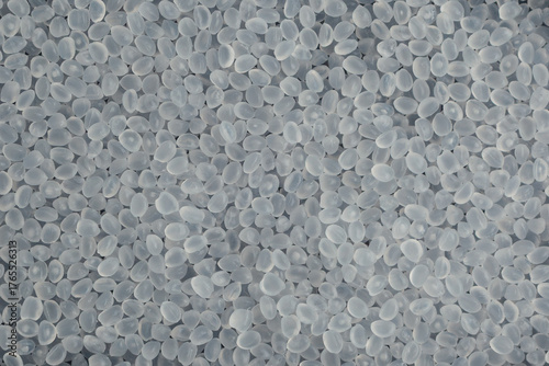 Virgin polypropylene pellets or PP granules, close-up. Base polymer for production of plastic packaging. Granulated plastic polymer