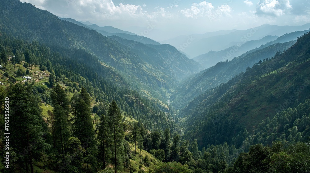 Fototapeta premium Serene mountain valley unfolds with lush green forests and distant mist filled peaks creating a breathtaking natural panorama