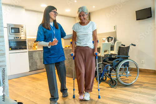 Nurse assisting senior woman with crutches rehabilitation