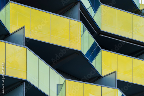 Yellow glass balcony architecture with strong geometric facade composition emphasizing minimal design and modern urban building structure captured in clean daylight perspective.