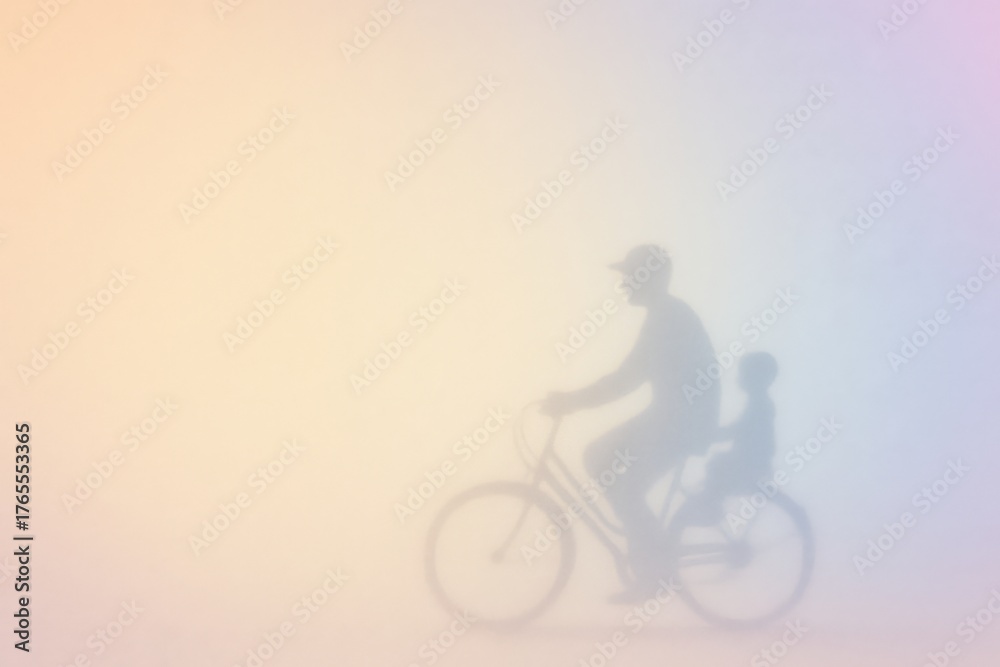 Obraz premium Father and Child Bicycle Silhouette on Pastel Gradient