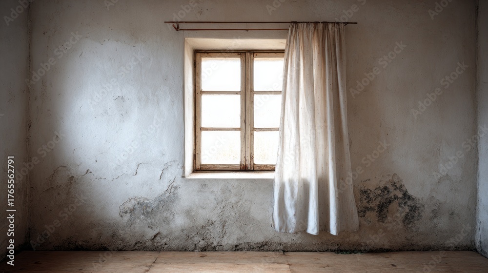 Fototapeta premium Faded light enters a room through a simple window covered by a curtain.