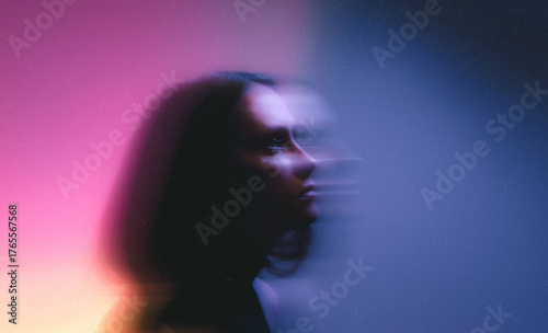 creative moody women portrait with neon colorful lighting and motion blur effect