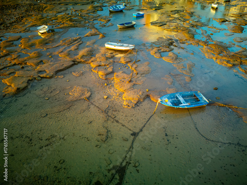 Wooden Boats Resting at Low Tide in the Warm Light of Sunset.
