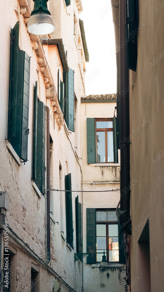 Fototapeta premium Venetian cityscape with close buildings and romantic old architecture