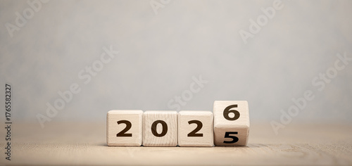 Wooden cubes changing year 2025 to 2026 on neutral background