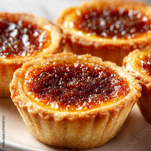 A tempting array of butter tarts, each boasting a perfectly golden crust and a luscious, caramelized filling, promising a delightful burst of sweet indulgence
