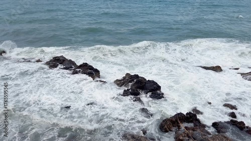 Mediterranean sea and rocks at shore captured in famous summer village called Antibes in French riviera.