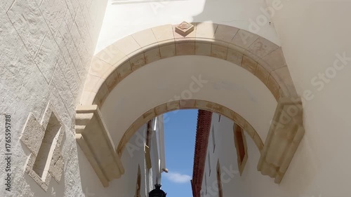 Bottom view of an old, traditional building in famous summer village called Sitges in Spain. It show Spanish architectural style. It is a sunny summer day.