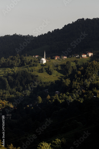 A Serene Hillside Village Featuring a Beautiful White Church at Dusk
