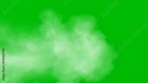 A plume of white smoke or steam captured against a vibrant green screen background, suitable for visual effects and compositing