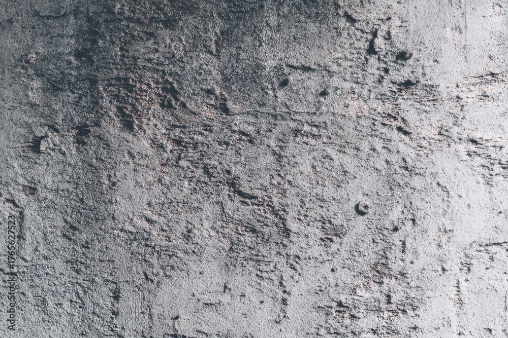 Fototapeta premium Textured gray concrete wall surface with rough patterns.