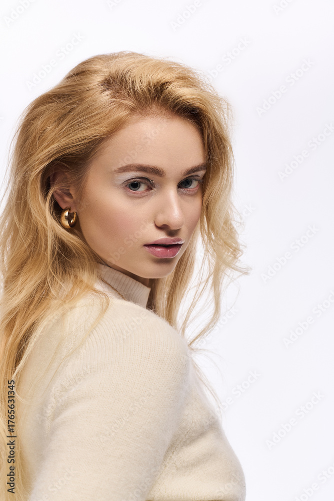 Fototapeta premium Winter elegance shines in a cozy knitted outfit with soft makeup tones