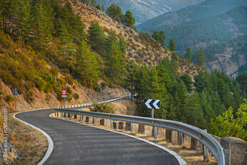 Vászonkép A mountain road with sharp turns between rocky canyons where the creeping vegeta