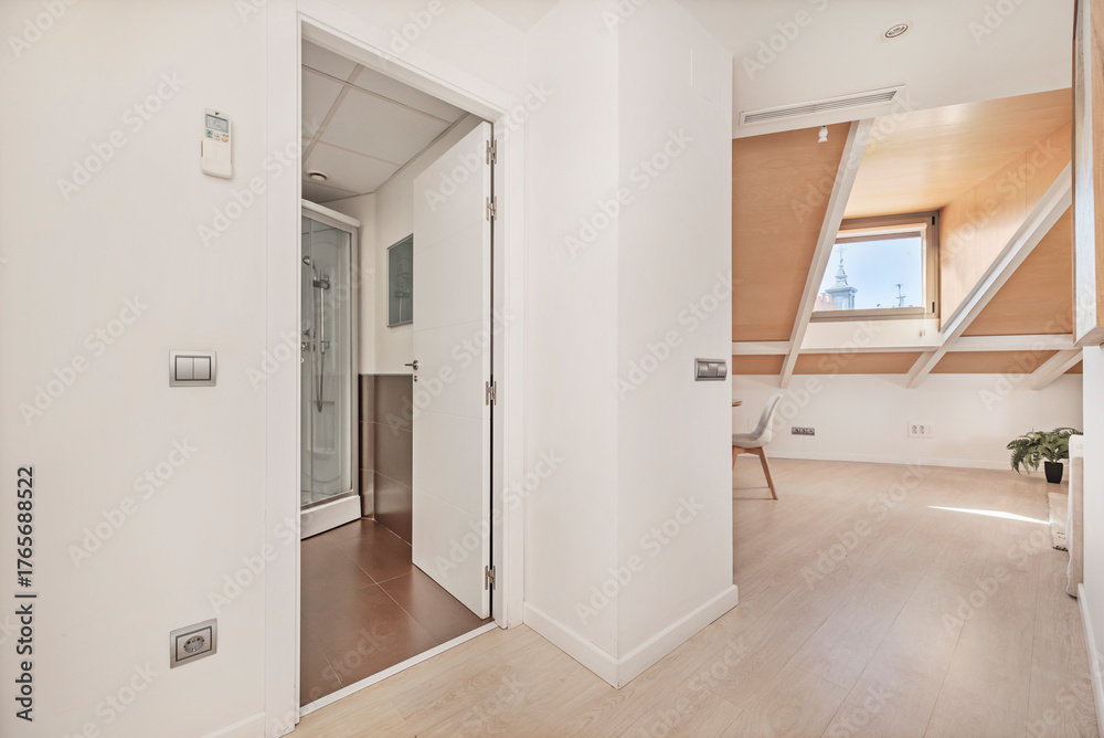 Fototapeta premium Hallway with wooden flooring and stucco walls, blending rusticity and modernity in a transitional space