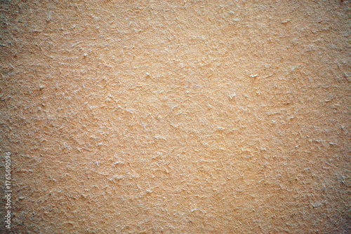 Warm beige texture with fibrous flecks, surface after removing wallpaper during renovation