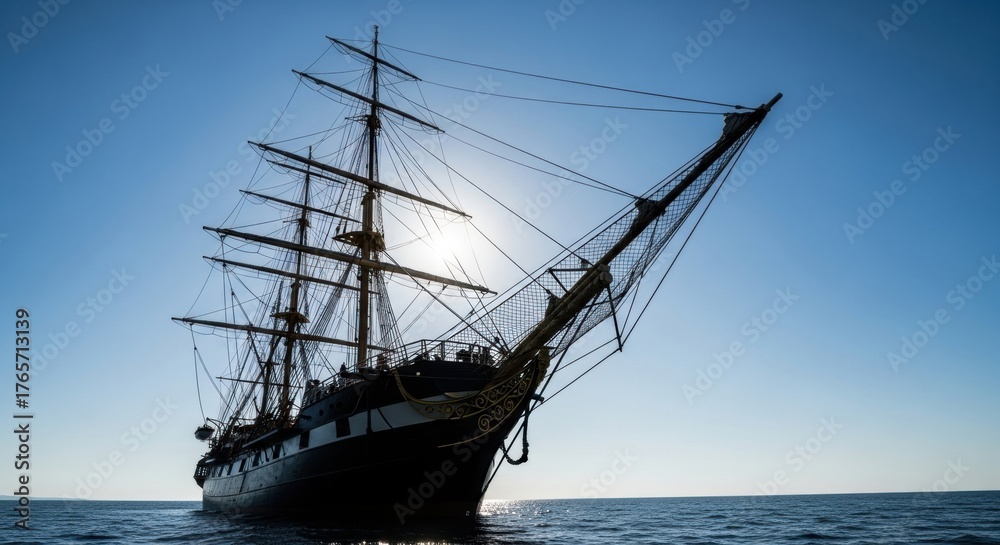 Obraz premium Majestic sailing ship on tranquil ocean at sunrise