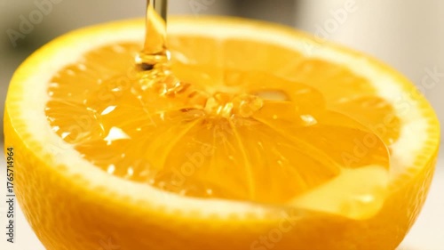 Honey Being Poured Onto Half a Lemon With Droplets Close Up