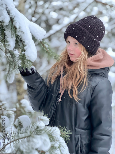 a teenage girl enjoys the snow, plays and has fun. winter holidays