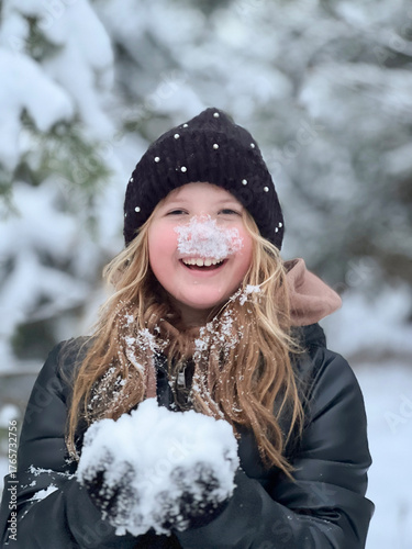 a teenage girl enjoys the snow, plays and has fun. winter holidays