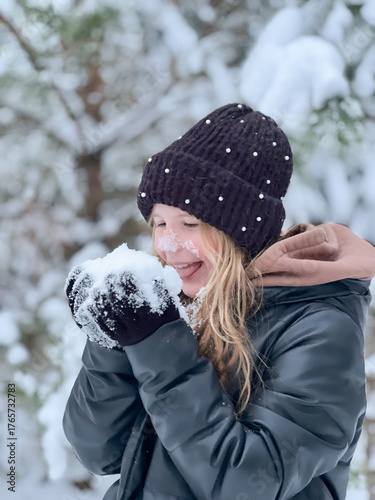 a teenage girl enjoys the snow, plays and has fun. winter holidays