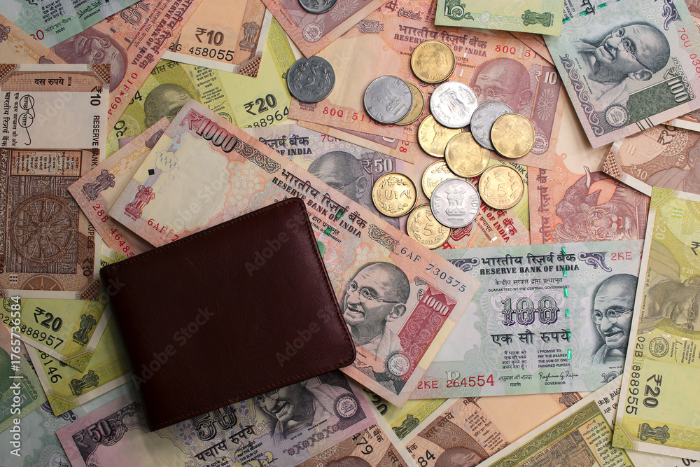 Φωτογραφία Closeup image of old Indian rupee notes (INR) and coins of different value and brown leather wallet, top view