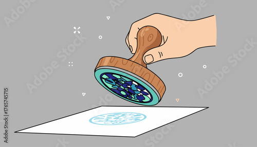 A hand holding a wooden stamp with a blue and green patterned rubber base is pressing down onto a white sheet of paper, leaving a circular imprint of the same pattern. The illustration is in a modern