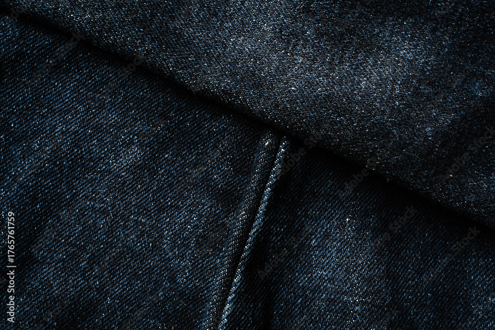 Naklejka premium Dark blue jeans with diagonal seam lines texture