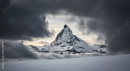 Majestic Matterhorn peak covered in snow, framed by dramatic, dark storm clouds.