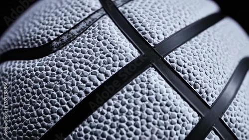 Close up of a textured basketball with black lines.