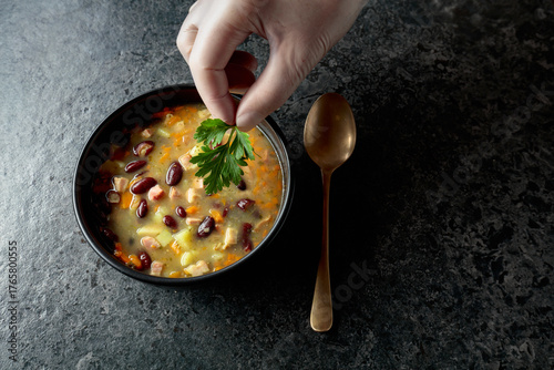 Fototapet Red bean soup with potatoes, tomatoes, paprika, carrot, and bacon