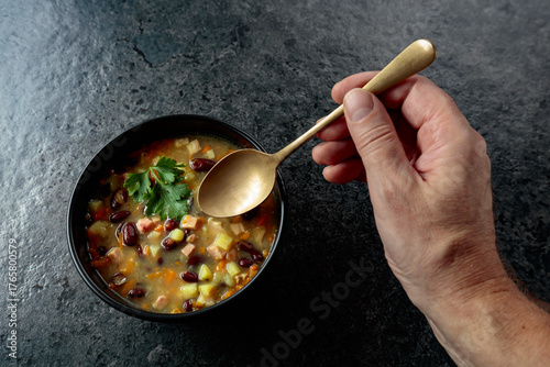 Fotografie Red bean soup with potatoes, tomatoes, paprika, carrot, and bacon