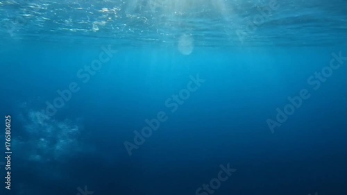 Underwater Scene with Bubbles Rising Towards the Surface, Capturing Light Rays in a Tranquil Ocean