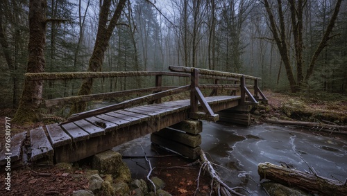 An old wooden bridge spans a tranquil stream within a serene forest, enveloped in a misty atmosphere and evoking a sense of calm solitude.
