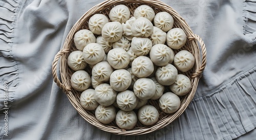 Top down view of traditional homemade white cookies in a wicker basket on a rustic tablecloth.