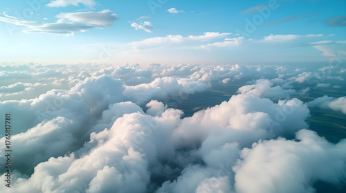 High altitude aerial view from a dron over a sea of clouds. Bird's eye perspective of a sunny cloudscape and blue sky