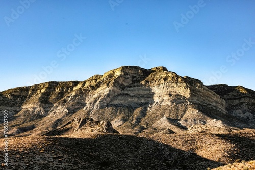 Majestic Crimson Sandstone Spires Pierce Azure Nevada Skies, Unveiling Ancient Desert Layers in Red Rock Canyon's Timeless, Sun-Drenched Embrace