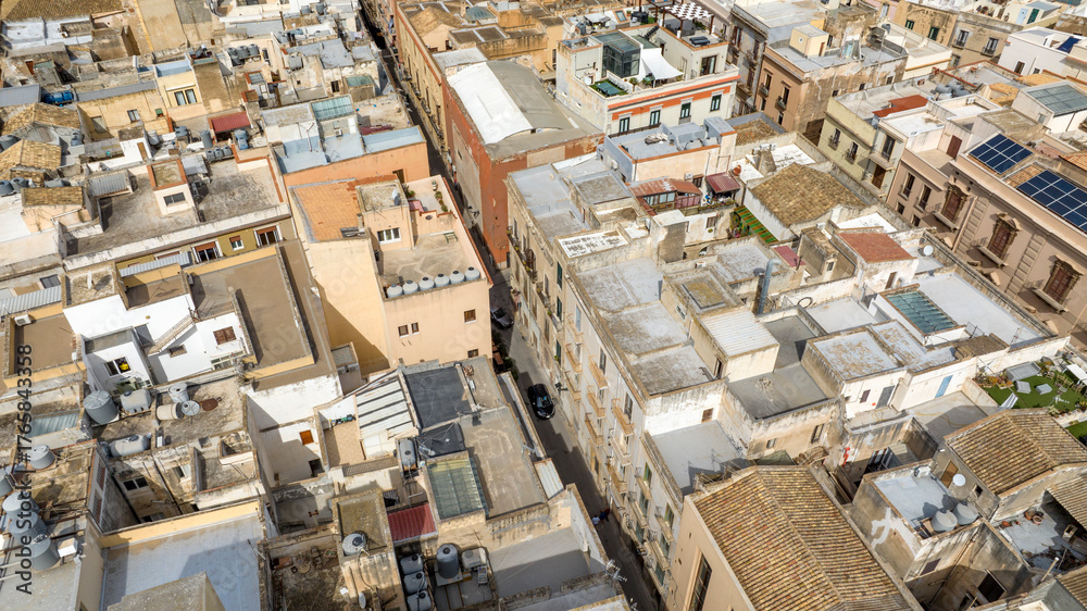 Fototapeta premium Aerial view of an alley in Trapani, Sicily, Italy. In the historic center of the city, among the narrow streets, there are many houses and palaces.