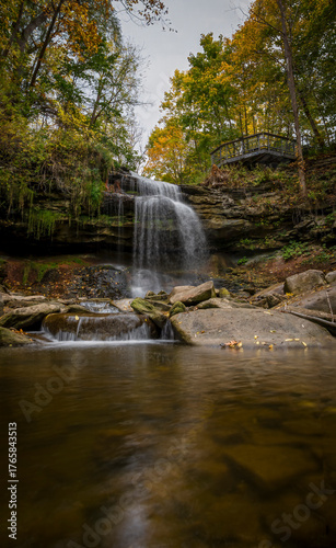 Smokey Hollow Falls, a hidden gem in Hamilton, Ontario, offers a serene and picturesque view of cascading waters amid lush autumn foliage.