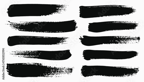 A collection of ten black brush strokes of varying textures and lengths on a white background
