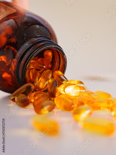 Dietary Supplements: Capsules Scattered from Container