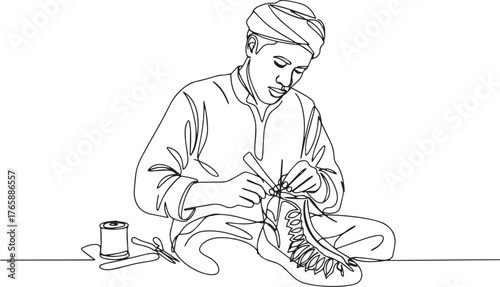 Craftsman creating traditional footwear with meticulous stitchin